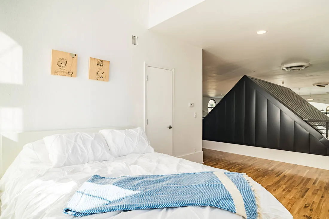Loft bedroom overlooking the tiny house roof